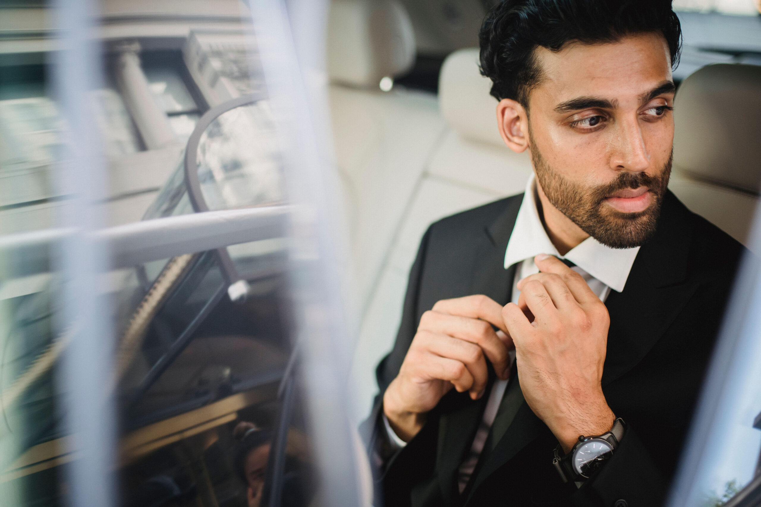 Chauffeur welcoming a client at Heathrow Airport with personalised signage